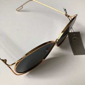 Oversized gold-framed sunglasses